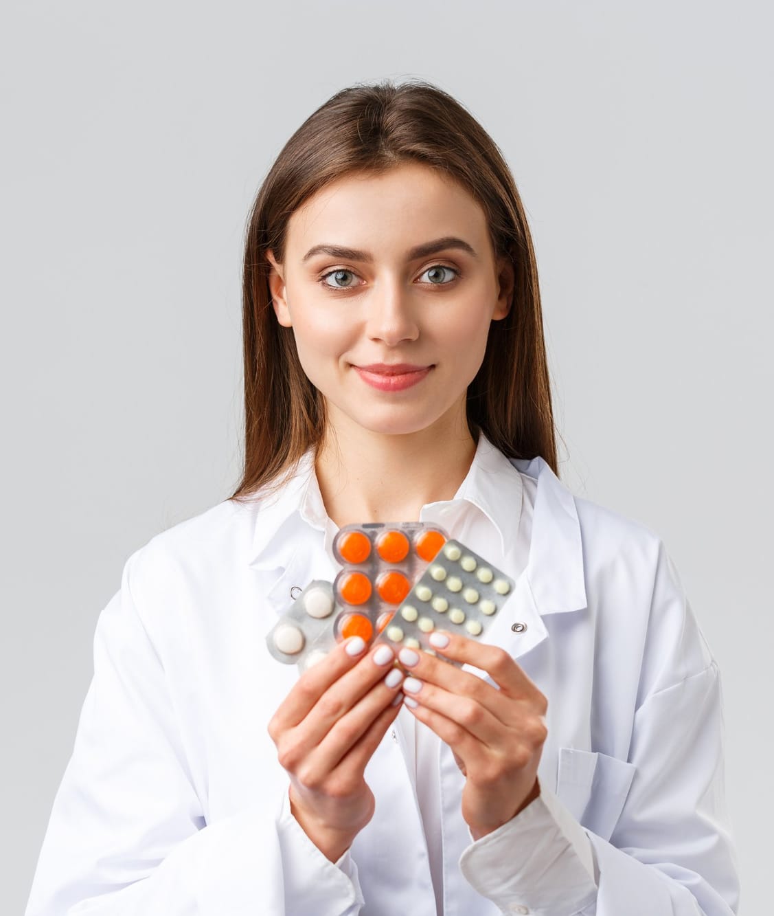 covid 19 preventing virus health healthcare workers quarantine concept physician medical white scrubs attractive female doctor showing medicine different pills smiling as recommend it